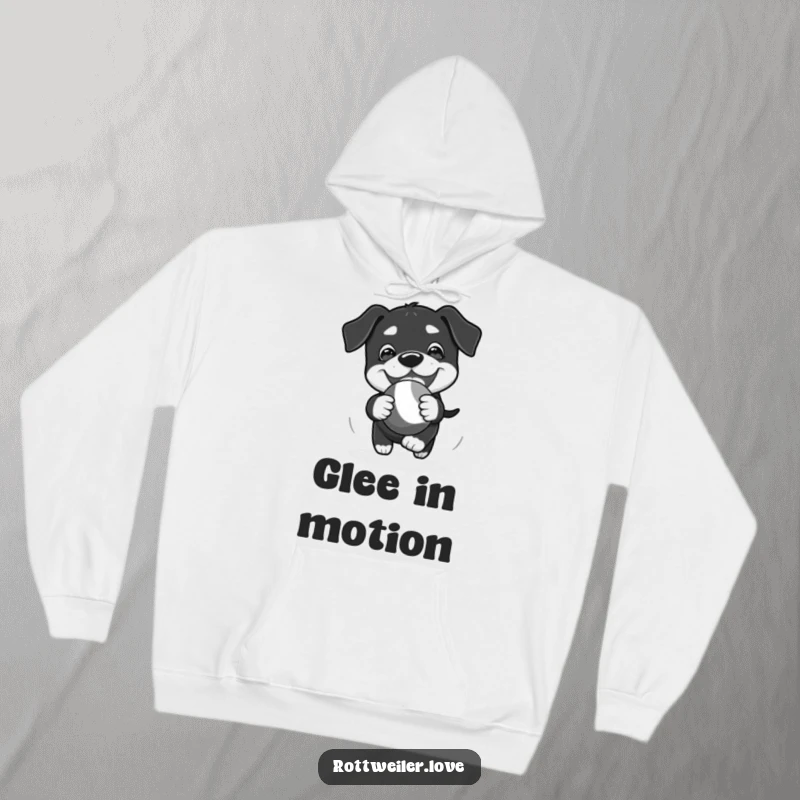 Funny Kawaii Rottweiler hoodie depicting a playful chase of a bouncy toy with glee, perfect for cozy fun.