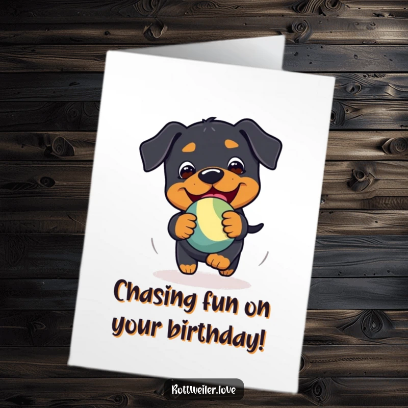 Funny Free Printable Birthday Card: A playful Kawaii Rottweiler gleefully chasing a bouncy toy with happy determination.