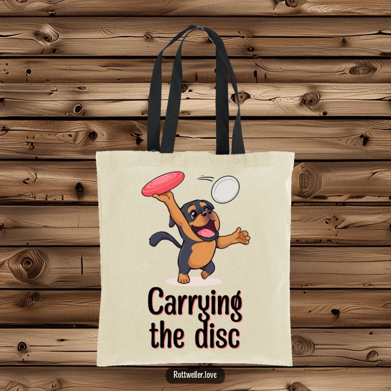 Funny Rottweiler tote bag showcasing an energetic dog leaping to catch a flying disc, a practical and sporty accessory for dog lovers.