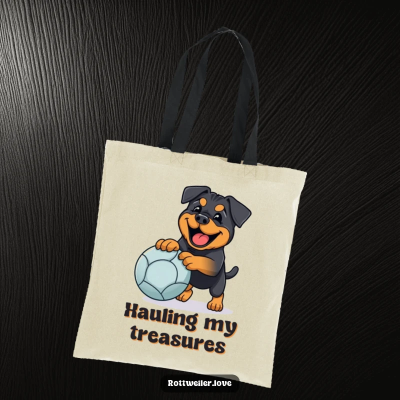 Funny rottweiler tote bag showing a happy dog playing fetch with a large ball, ideal for humorous, practical carrying.