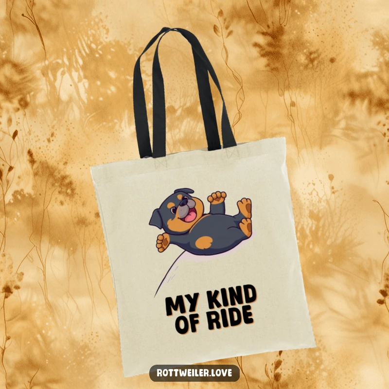 Funny Rottweiler tote bag with a dog sliding happily on its back, paws in the air, a comical and delightful sight.